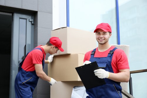 Workers loading household furniture during a Barking collection