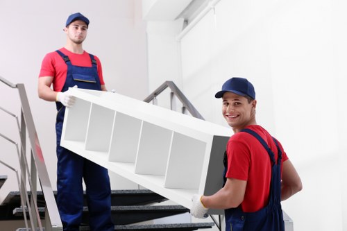 Students moving boxes and furniture in Barking