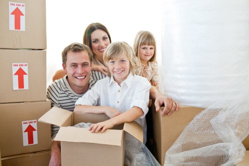Careful transport of a piano through a residential property in Barking
